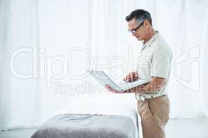 Physiotherapist using laptop