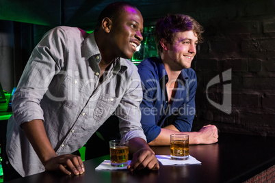 Two men having whiskey at bar counter