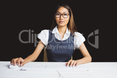 Serious businesswoman using a computer