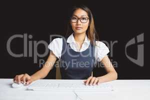 Serious businesswoman using a computer