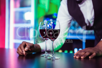 Two glasses of wine on bar counter