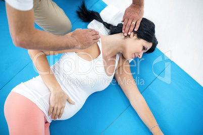 Doctor giving physiotherapy to pregnant woman