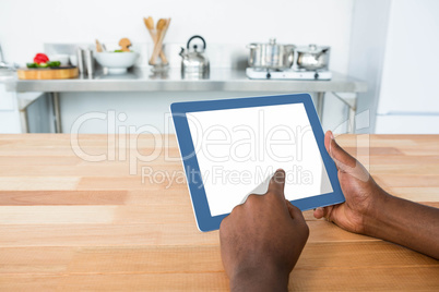 Man using digital tablet in kitchen