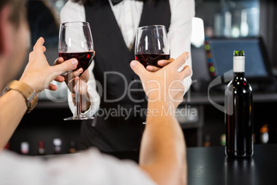 Bartender serving glasses of wine