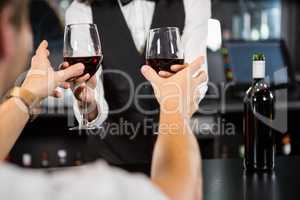 Bartender serving glasses of wine