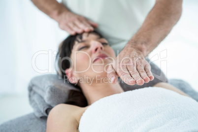 Pregnant woman receiving a massage from masseur