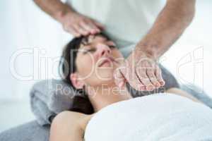 Pregnant woman receiving a massage from masseur