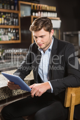 Handsome man using tablet computer Handsome man using tablet computer