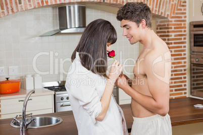 Man giving red rose to woman