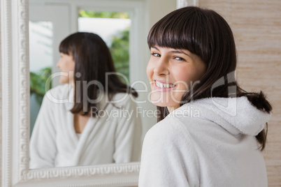 Beautiful young woman in white bathrobe