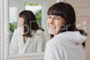 Beautiful young woman in white bathrobe