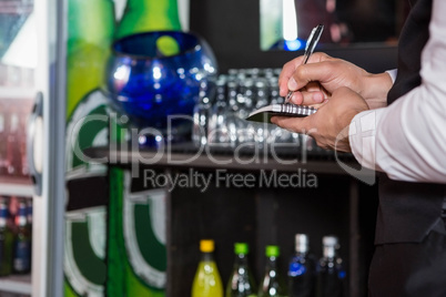 Waiter writing down an order