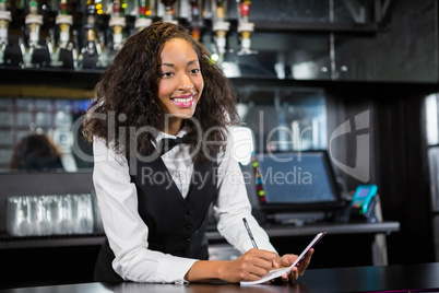 Waitress writing down an order