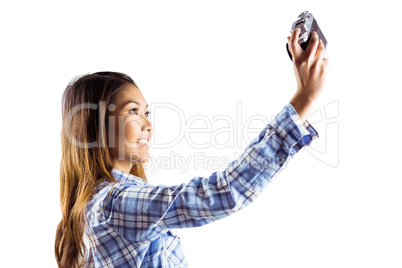 Smiling asian woman taking picture with camera