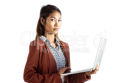 Serious businesswoman using laptop