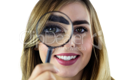 Smiling woman using magnifying glass