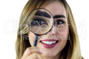 Smiling woman using magnifying glass