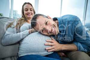 Man listening to pregnant womans stomach