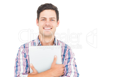 Portrait of smiling male student holding a laptop