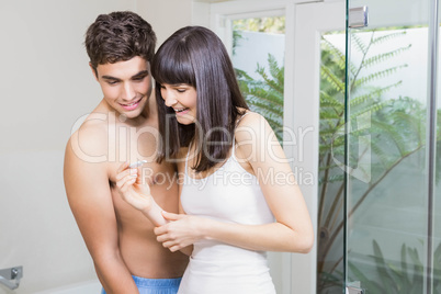 Young couple checking results of pregnancy test