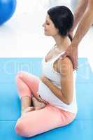 Doctor giving physiotherapy to pregnant woman