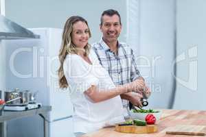Portrait of pregnant couple in kitchen