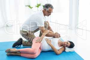 Doctor giving physiotherapy to pregnant woman