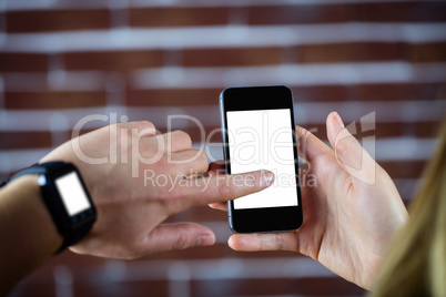 Feminine hands using smartphone and smart watch