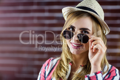 Smiling woman touching her sunglasses