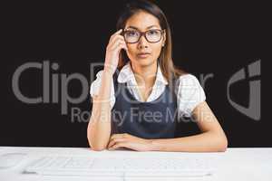 Serious businesswoman holding her eyeglasses