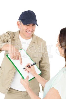 Female customer signing on paper with delivery man