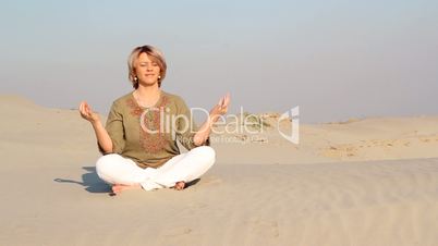 woman meditating in desert