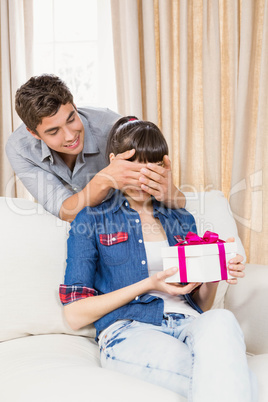 Young woman receiving a surprise gift