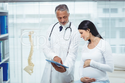 Pregnant woman interacting with doctor