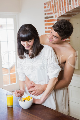 Young couple embracing while having breakfast