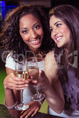 Happy young women having champagne