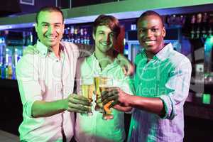 Group of men toasting with glass of beer