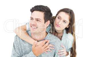 Couple embracing with arms around and looking away