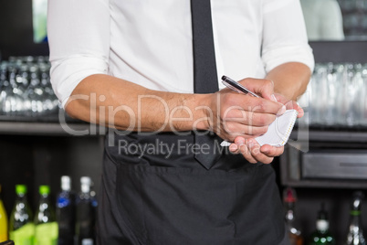 Waiter writing down an order