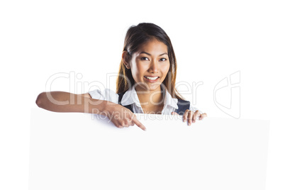 Smiling businesswoman pointing a white poster