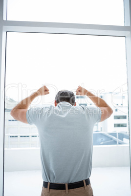 Tensed man leaning on glass window