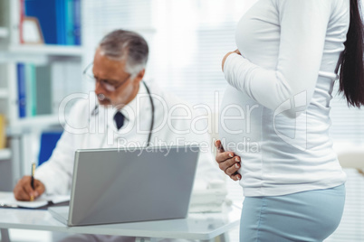 Pregnant woman holding her stomach