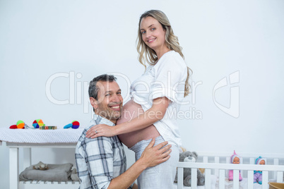 Man touching the belly of pregnant woman