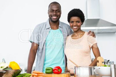 Pregnant couple embracing in kitchen