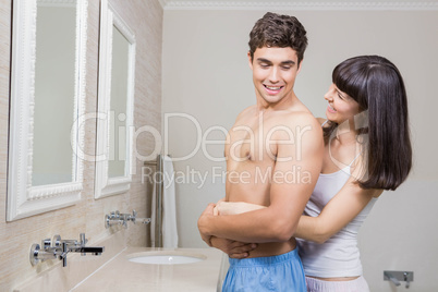 Young couple embracing in bathroom