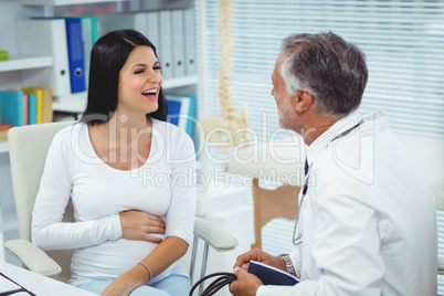 Pregnant woman talking to doctor