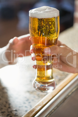 Close up of masculine hands giving a pint