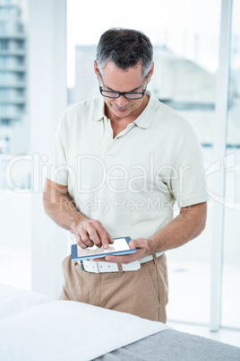 Physiotherapist using digital tablet