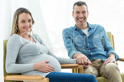 Couple sitting on chair and smiling