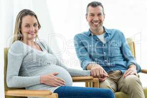 Couple sitting on chair and smiling